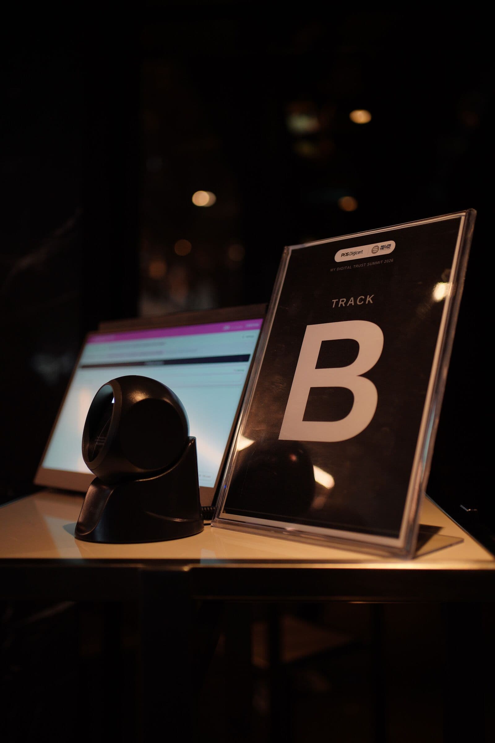 Check-in kiosk with a scanner and a 'Track B' sign at MY Digital Trust Summit 2026