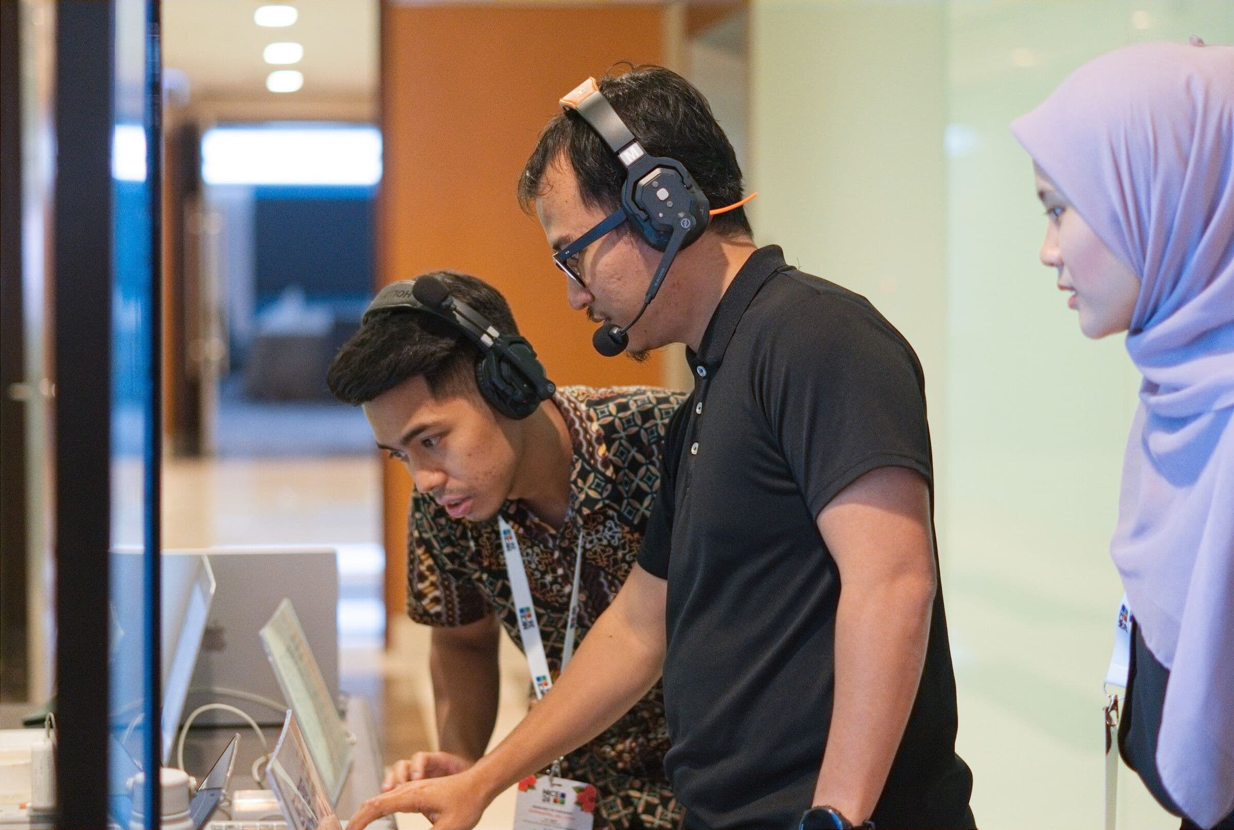 Event crew with headsets at a check-in station, NICE 2026