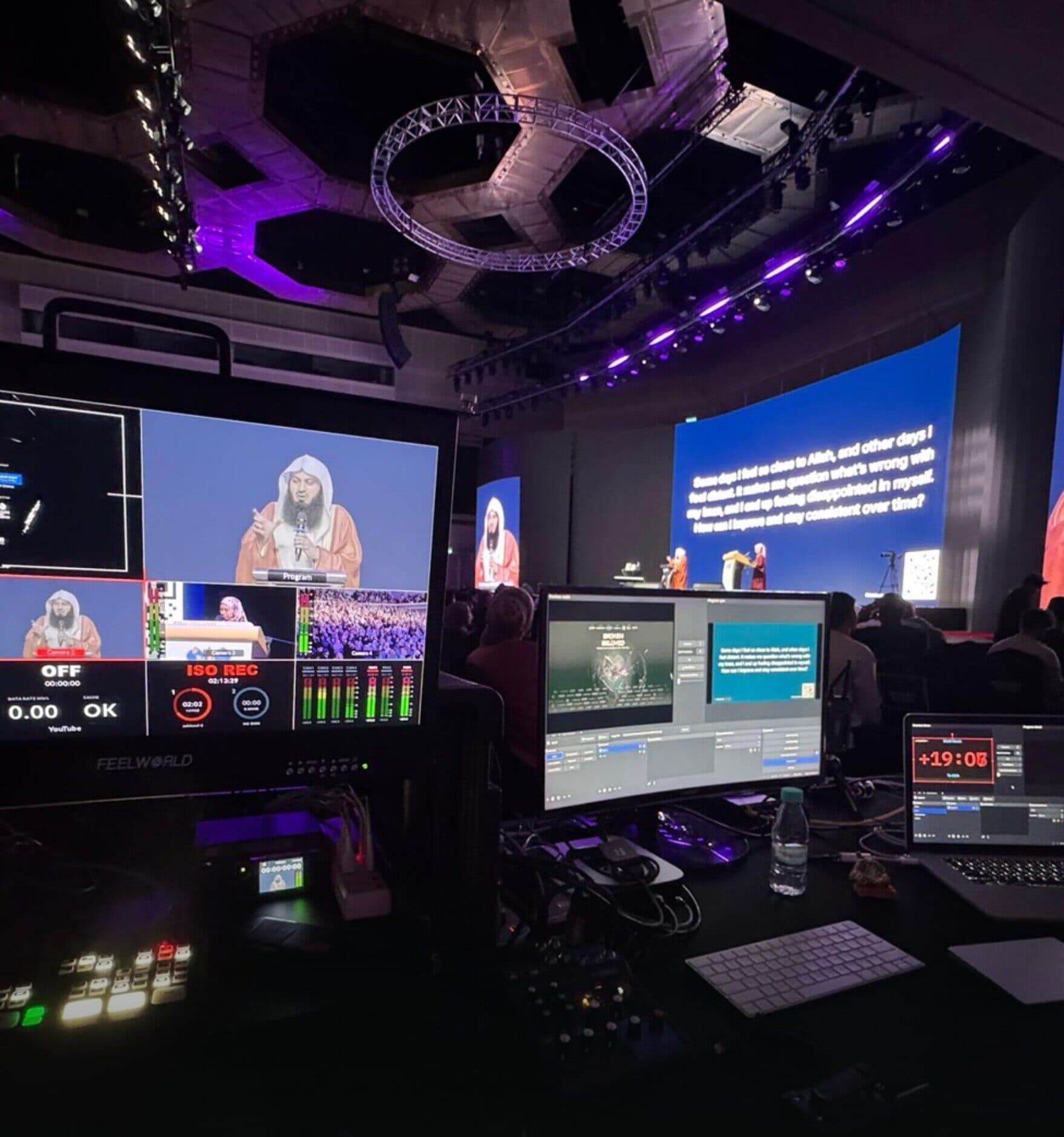 Live production desk with camera feeds and a countdown timer during a Faith Events talk