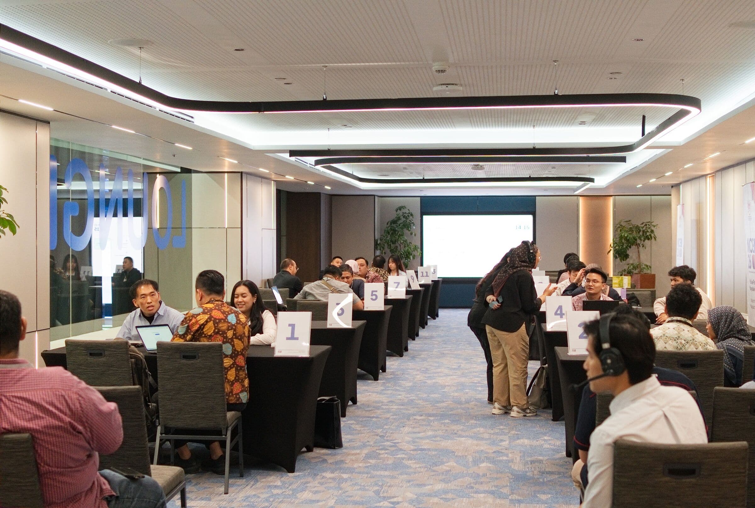 Founders and investors in 1:1 meetings at numbered tables, NICE 2026