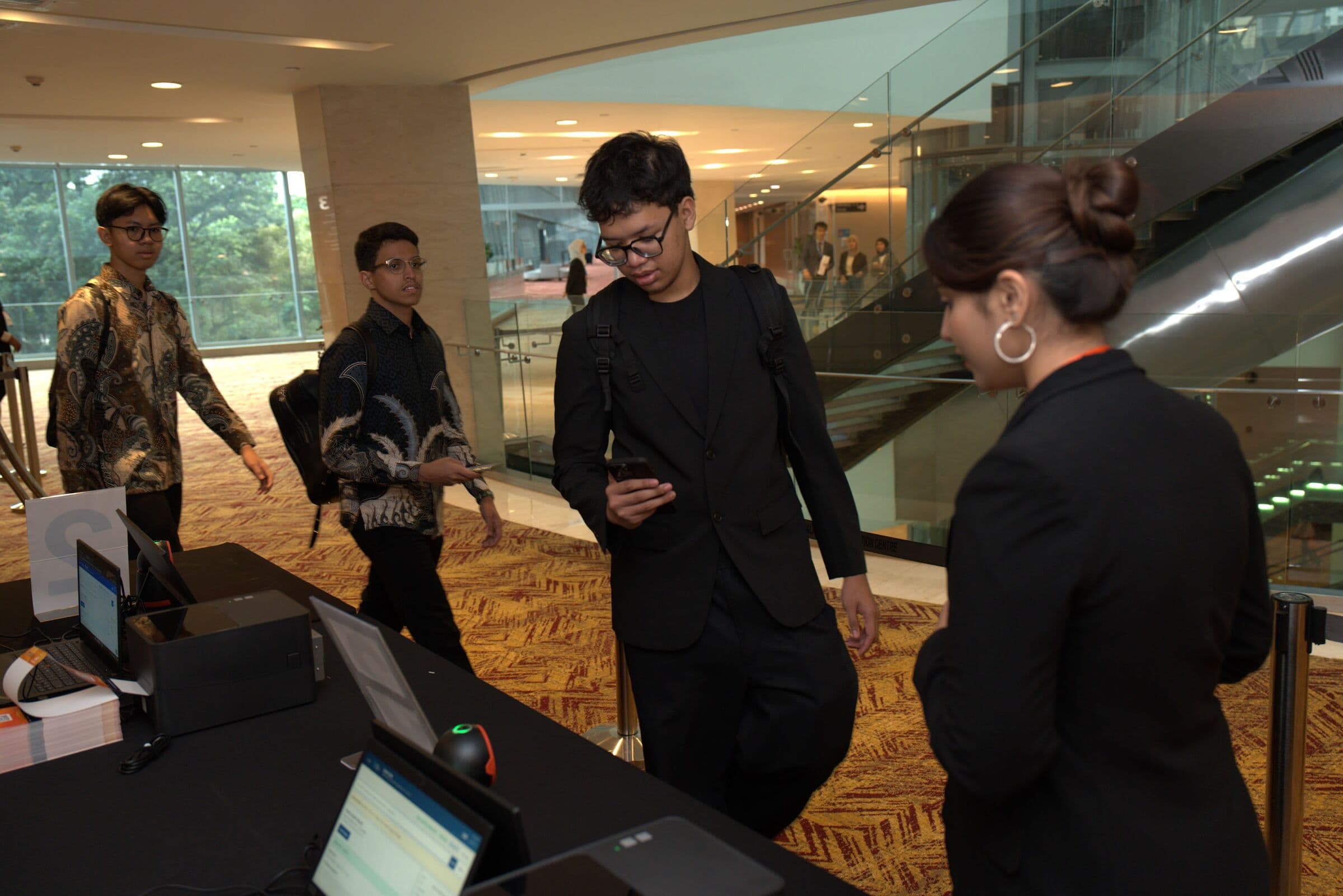 Attendees scanning in at the registration desk, Youth Economic Forum 2026